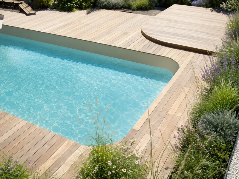 Plage de piscine en bois aux lignes courbes avec plateforme arrondie